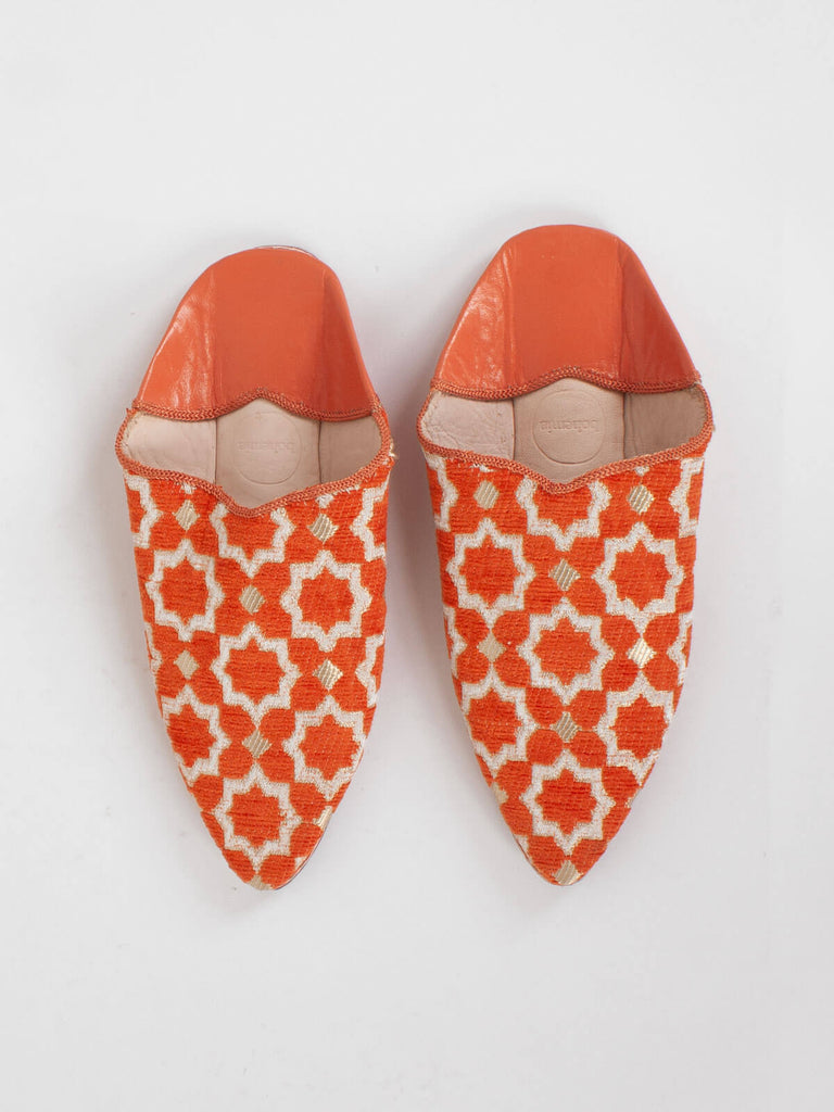 A pair of Moroccan Star Brocade Pointed Babouche Slippers in vibrant Orang
