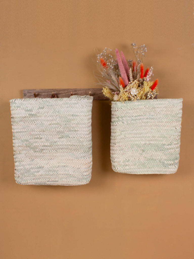 Hanging wall baskets handwoven from palm leaf and finished with a natural leather loop