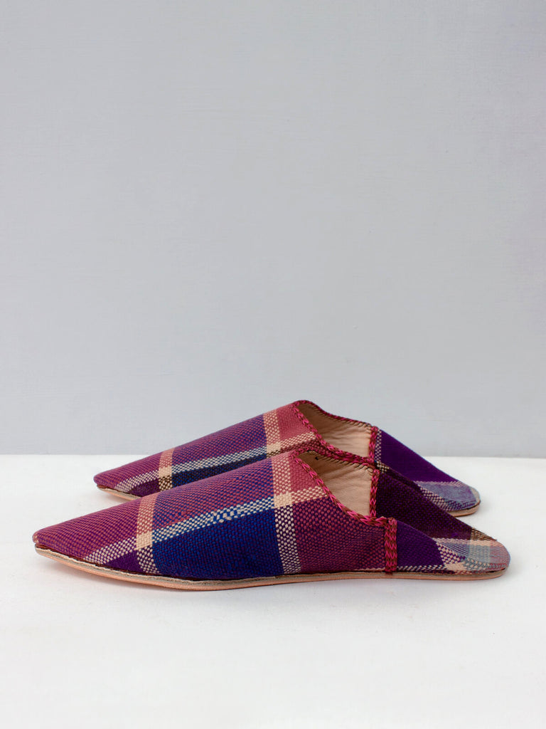 Side view of a pair of handmade natural leather and woven fabric Moroccan Boujad pointed babouche slippers with a unique purple plaid pattern by Bohemia Design