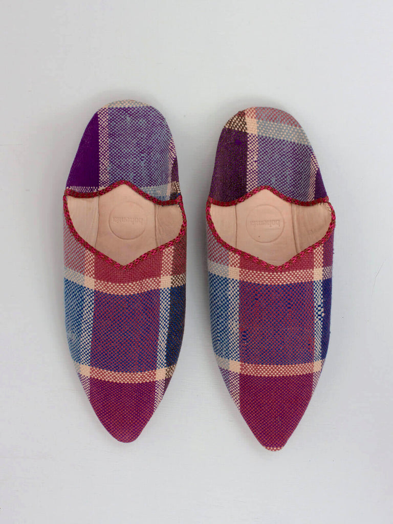 A pair of handmade natural leather and woven fabric Moroccan Boujad pointed babouche slippers in a unique purple plaid pattern by Bohemia Design