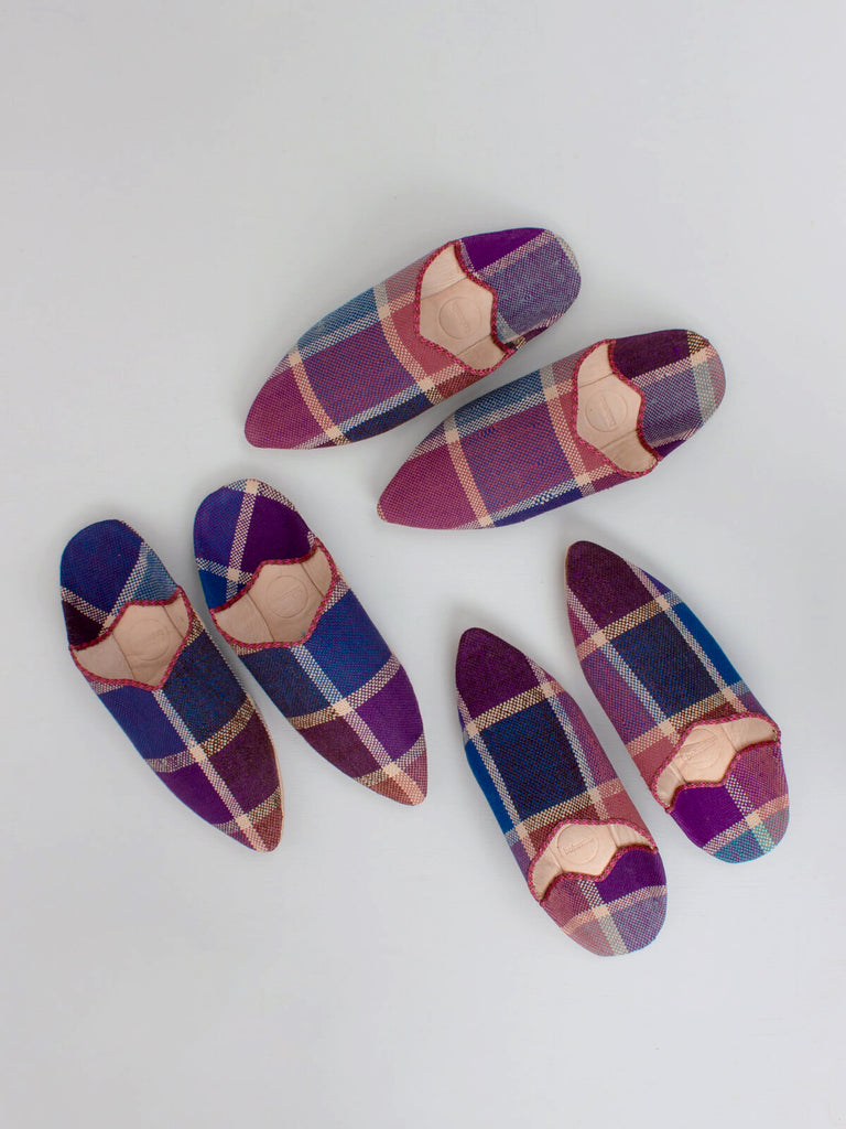 A group of handmade natural leather and woven fabric Moroccan Boujad pointed babouche slippers with a unique purple plaid pattern by Bohemia Design