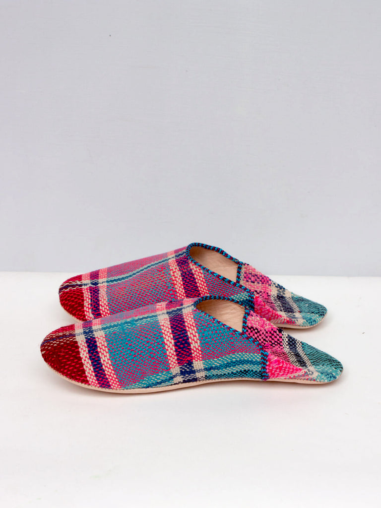 A close up of a pair of limited edition Moroccan Boujad Fabric Basic Babouche Slippers, Essaouira Check in pink and blue plaid by Bohemia Design