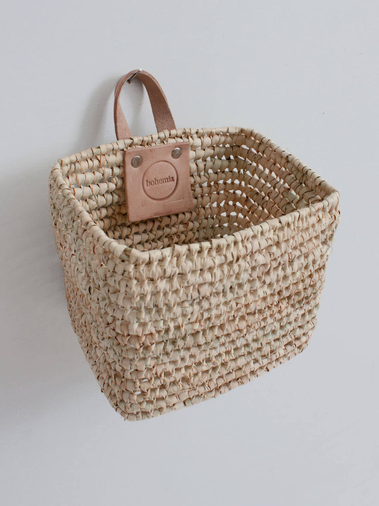 Square shape Mini woven wall hanging storage basket with leather loop hook and natural open weave design.