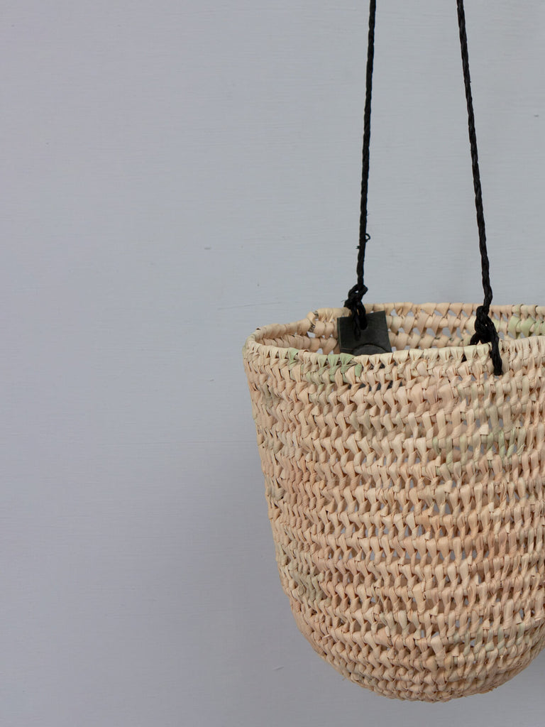 Natural woven indoor hanging planter with black leather thongs and Bohemia label