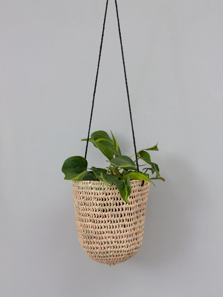 Small natural woven indoor hanging basket with finely braided black leather 