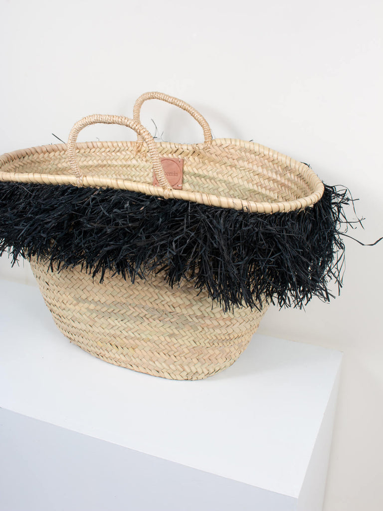 The medium size Raffia Tassel Basket in Black, handmade by Bohemia Design