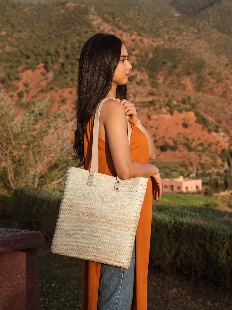 Asilah Shopper Basket by Bohemia Design worn by a woman overlooking Moroccan mountains