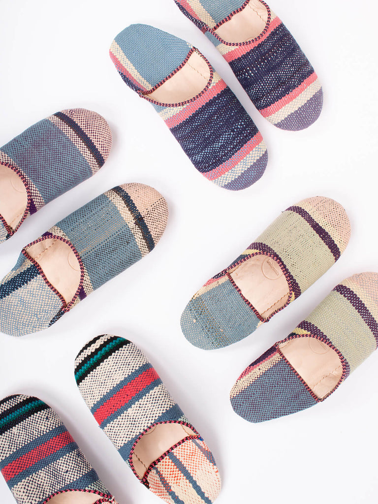 Various pairs of Moroccan boujad babouche slippers in muted stripe pattern by Bohemia design
