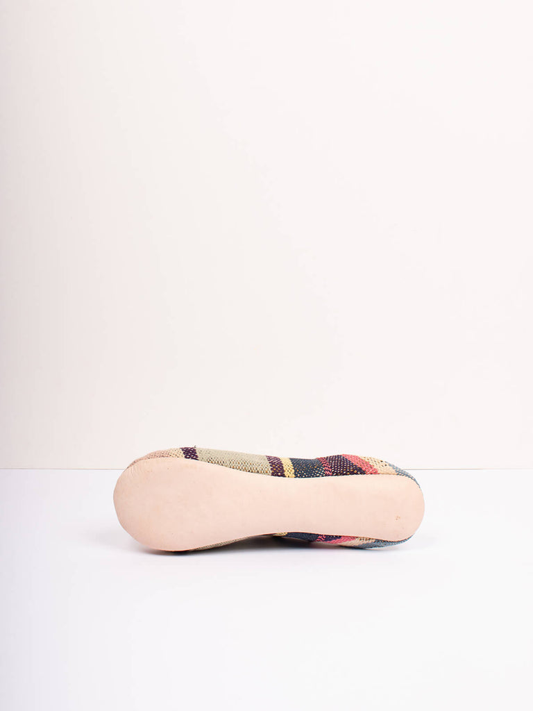 Underside of Moroccan boujad babouche slippers in muted stripe pattern by Bohemia design