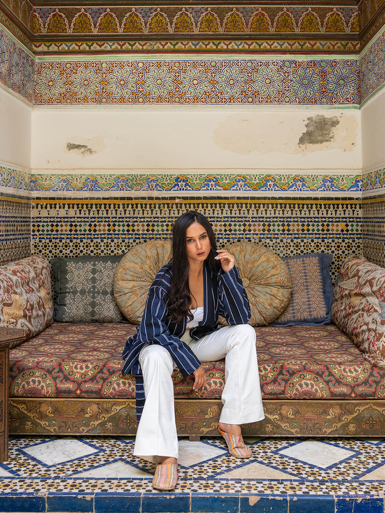 Model wearing Bohemia Design handwoven cotton jacket in navy and stripe at Moroccan riad