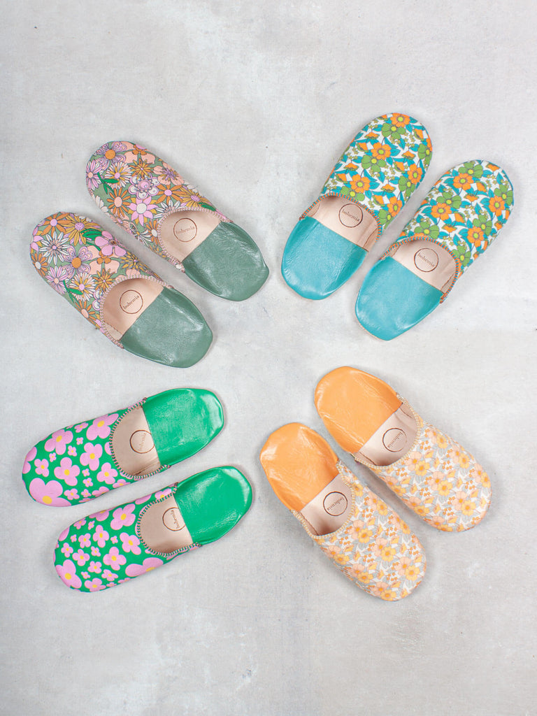 Four pairs of Margot Babouche slippers in various colours and patterns against grey tiles