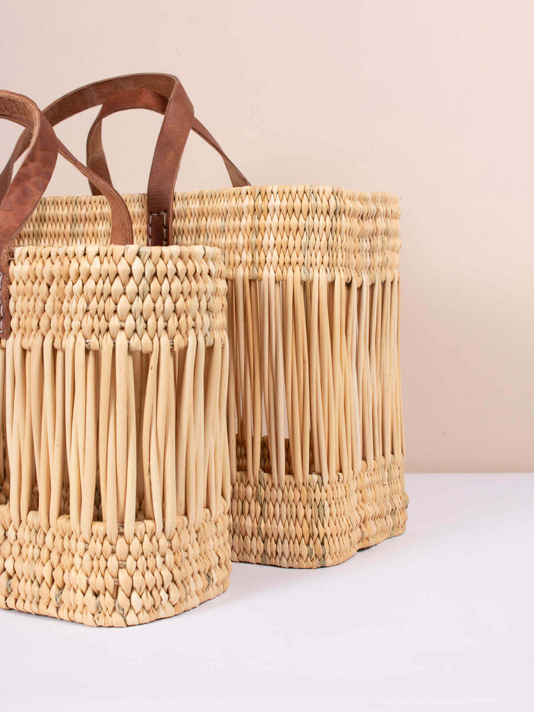 Sturdy rectangle shaped woven reed baskets with decorative handwoven design and leather handles
