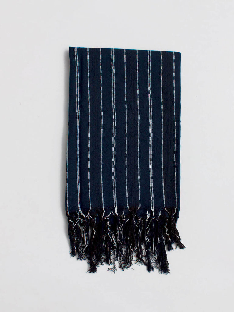 Hydra hammam towel in deep indigo blue with fine stripes and a hand tied tassel trim
