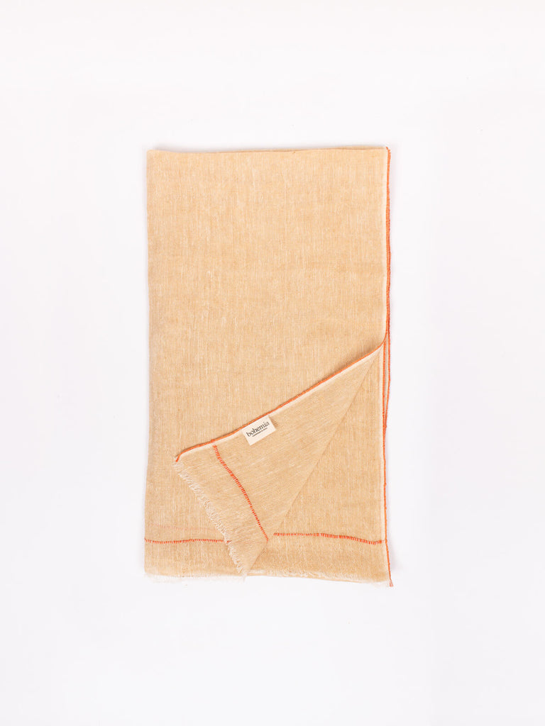 Folded mustard coloured Linen Scarf showing the orange detail along edges.