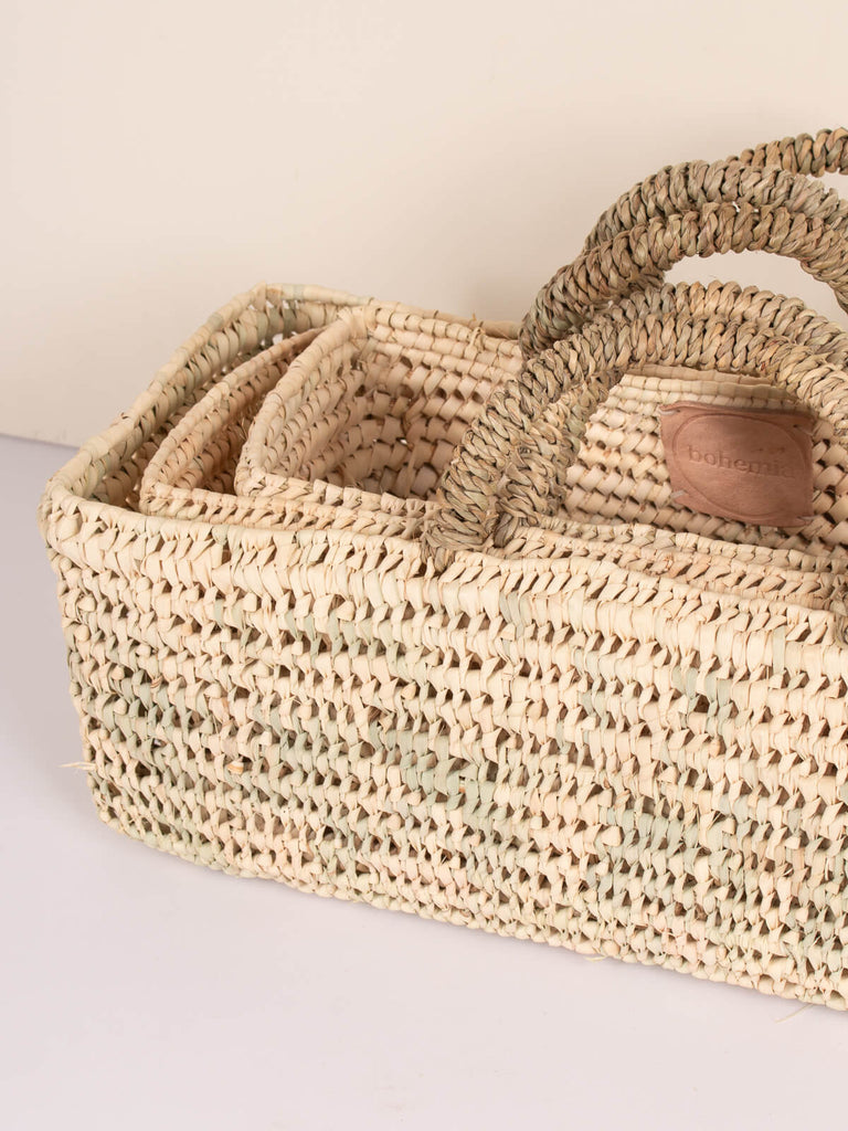 Set of three different sized long open weave storage baskets by Bohemia Design
