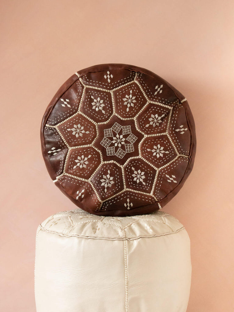 The embroidered top panel of a Chocolate Mocha Oiled Moroccan Leather Pouffe 