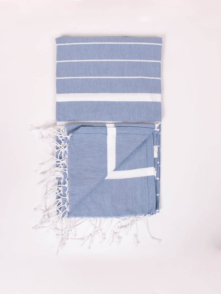 Soft blue cotton hammam towel with white striped pattern and hand knotted tassels