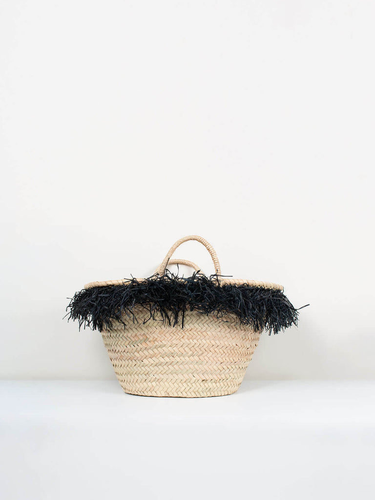 Small handmade Raffia Tassel Basket fringed with black raffia tassels.
