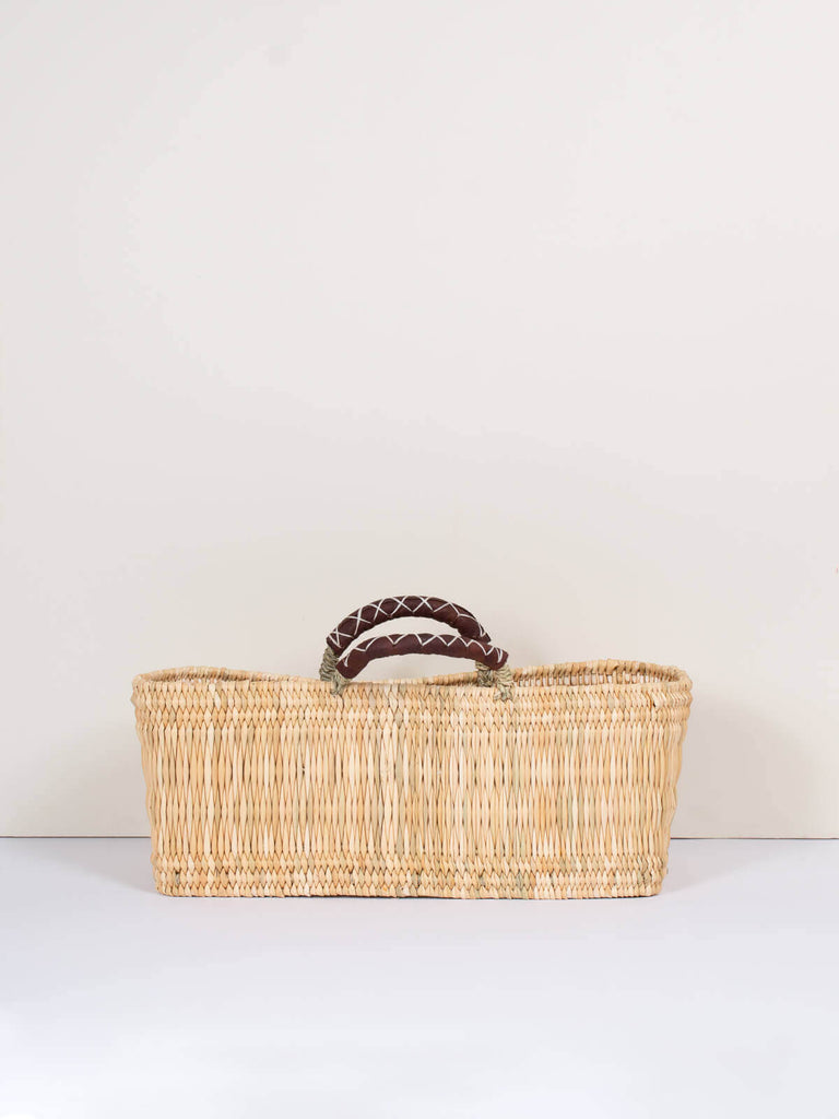 Large handwoven rectangular natural reed wicker basket with leather handles