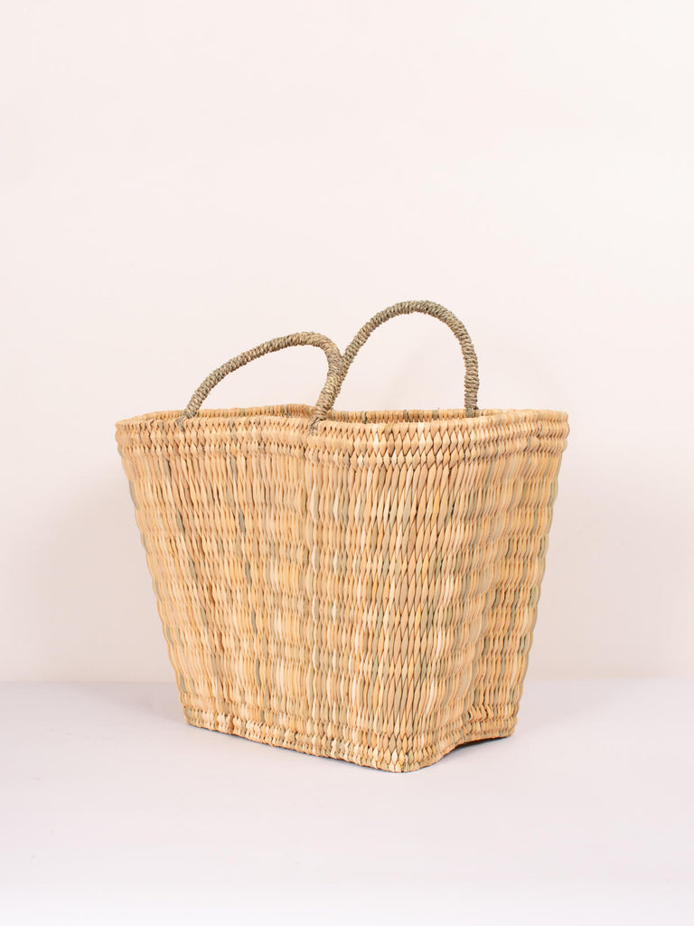 Tall rectangular shaped handwoven natural reed shopping or storage basket with handles by Bohemia Design
