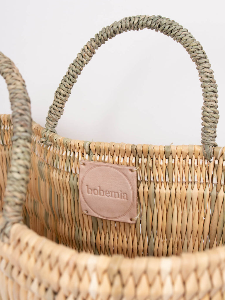 Sturdy sisal handles and hand stamped Bohemia leather label inside a reed shopper basket