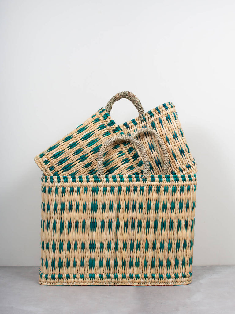 Set of three different sizes of natural woven storage basket bags featuring a skillfully weaved green pattern by Bohemia Design