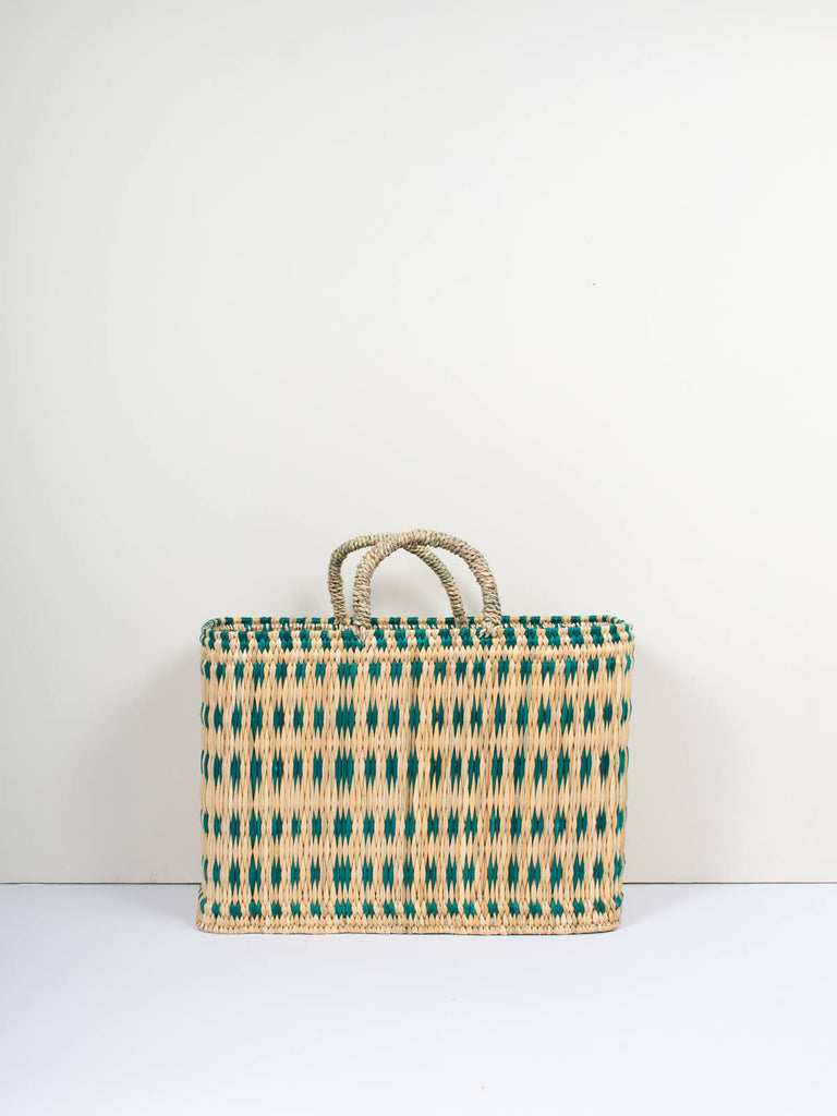 Large natural woven reed basket bag with handles and skillfully weaved green pattern by Bohemia Design