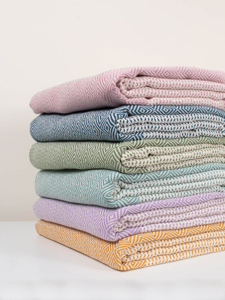 Pile of folded colourful Nordic Dot hammam towels by Bohemia Design