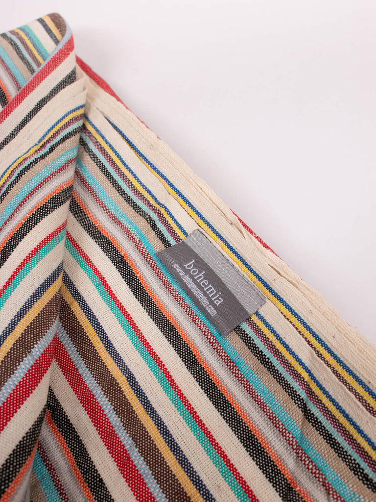 Hammam towel in rainbow stripe pattern with tassels