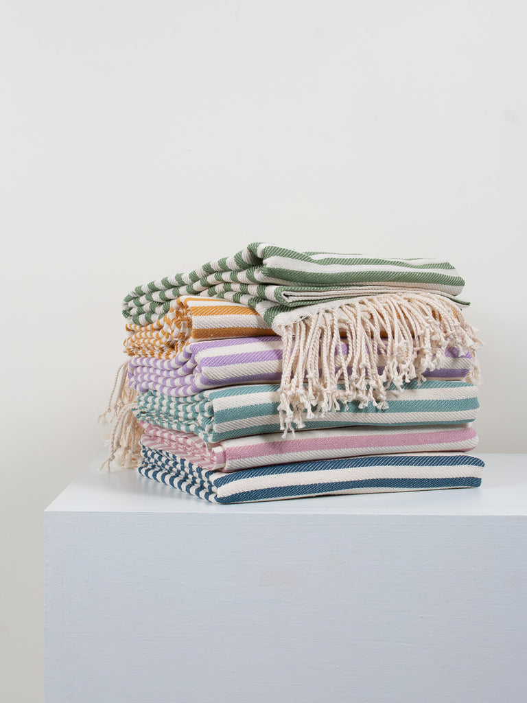 Pile of folded colourful Nordic Dot hammam towels by Bohemia Design