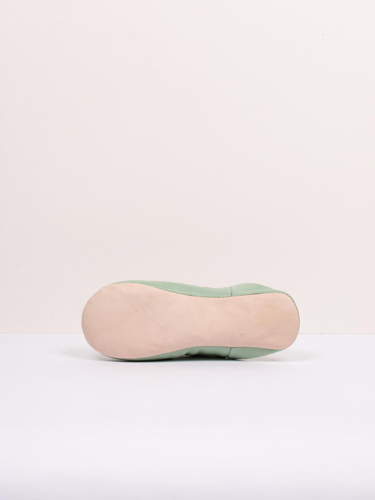 Underside of Moroccan babouche mule slippers in sage green leather by Bohemia Design