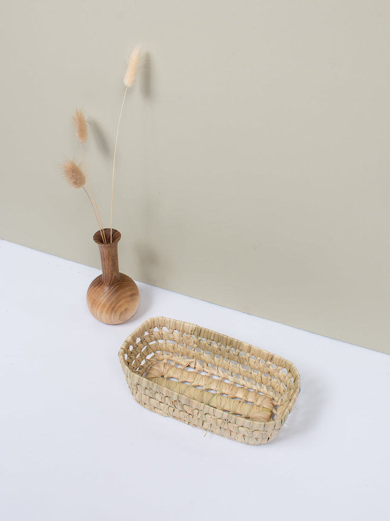 Small natural woven storage basket tray with decorative open weave design