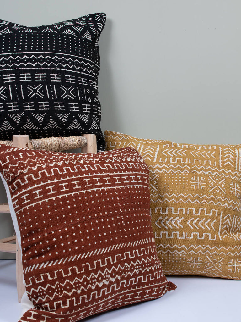 A group of three cushions with mudcloth patterns by Bohemia Design