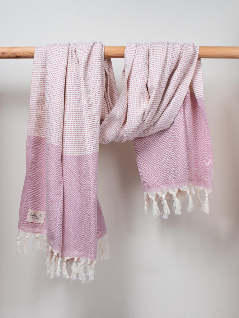 Nordic Dot Hammam Towel in vintage pink diamond pattern by Bohemia Design hanging on a wooden rail