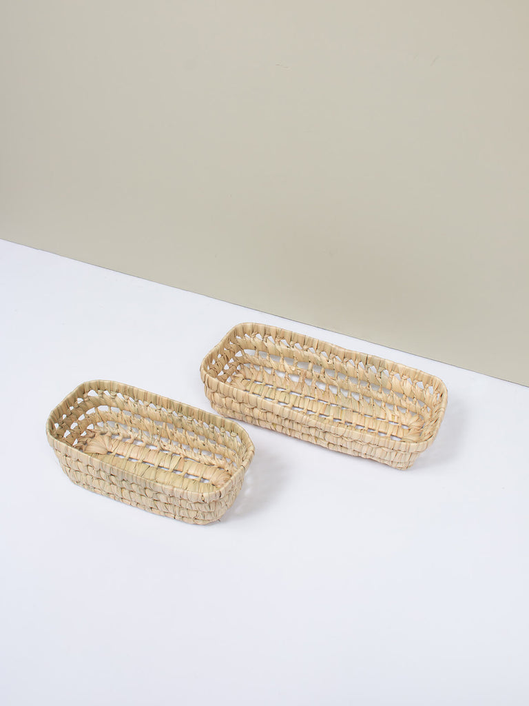 Two different sizes of  natural woven storage basket tray with decorative open weave design