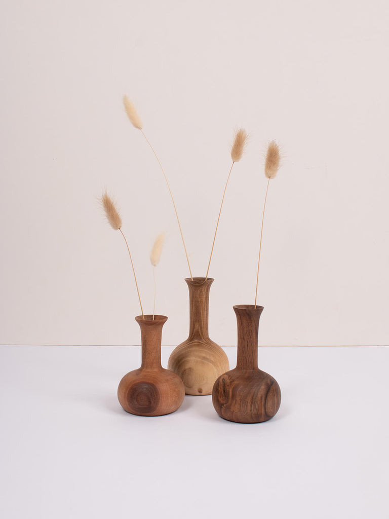Set of three mini wood vases with dried flowers