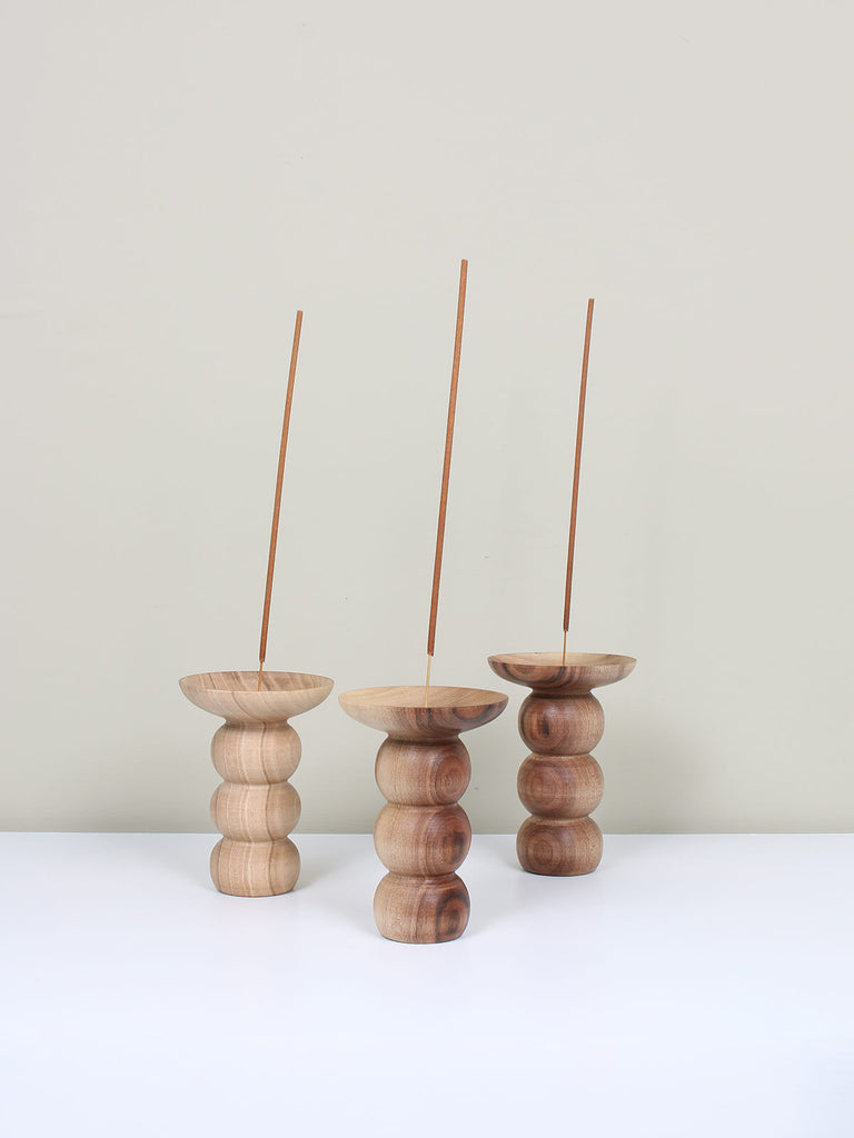 Set of Natural walnut wood incense holders in a stacked bubble shape with sticks of incense
