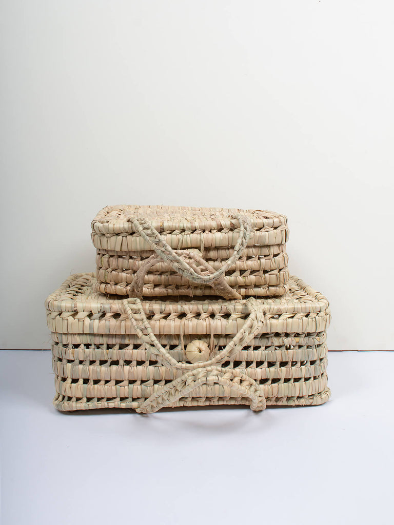 A small and large natural woven wicker suitcase basket with double handles by Bohemia Design