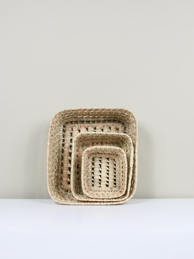 Three sizes of nesting woven basket trays crafted from natural plant fibres