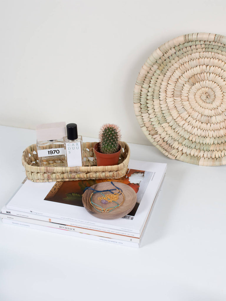 Mini woven rectangular storage basket tray as a catch all for beauty products, perfume and tiny cactus.